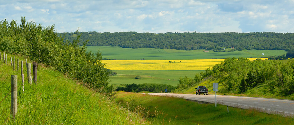 Single car traveling on rural road.